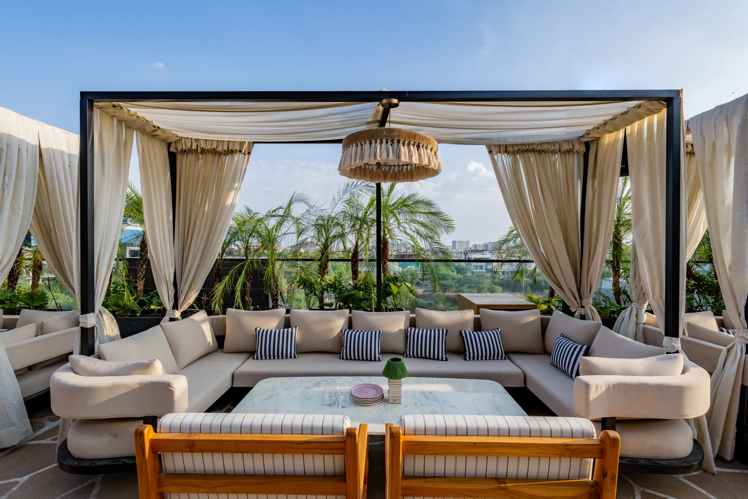 A cabana by day — cream sofas and striped cushions