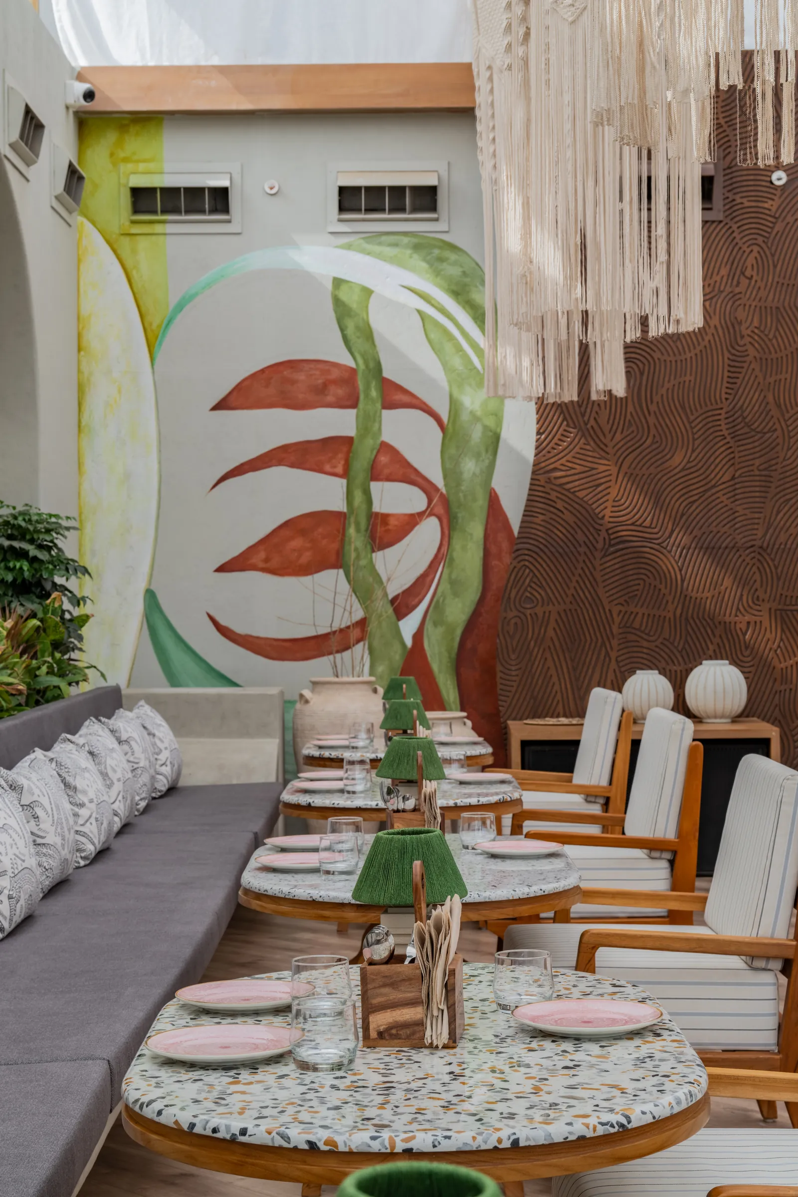 A botanical mural beside the banquette