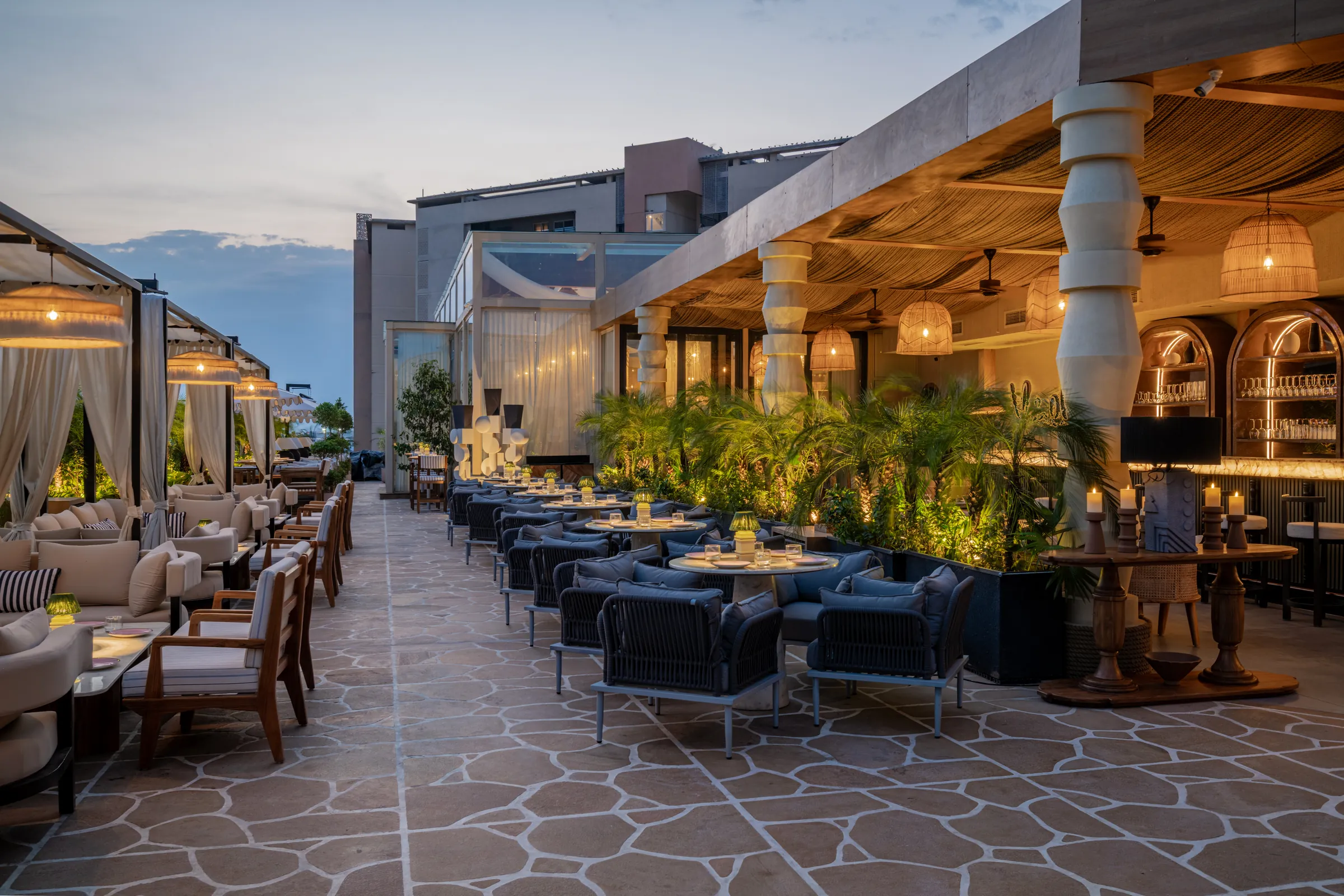 The long terrace at blue hour, lanterns lit